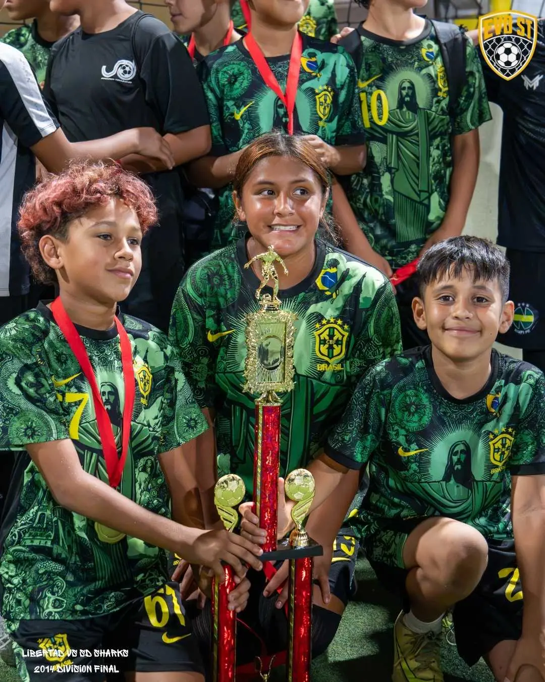 Youth champions hold the trophy after a division final at EVO St in San Diego