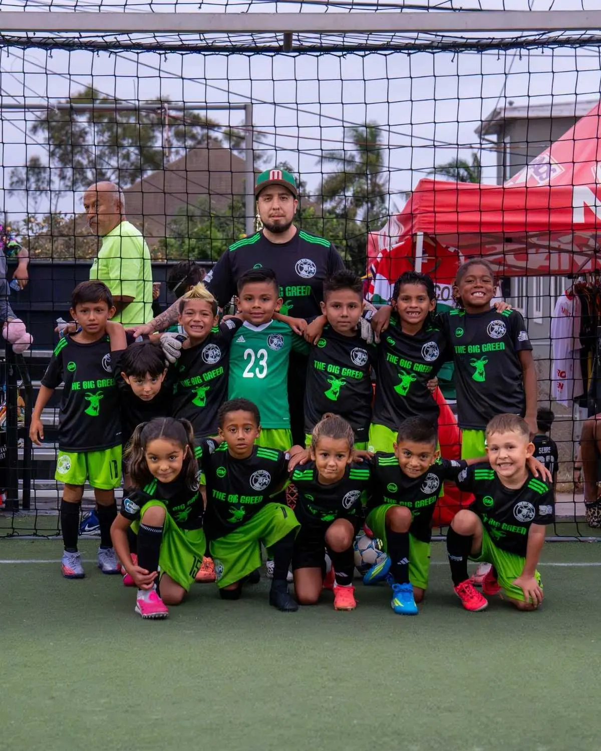 Youth team and coach pose in front of the goal at EVO St in San Diego